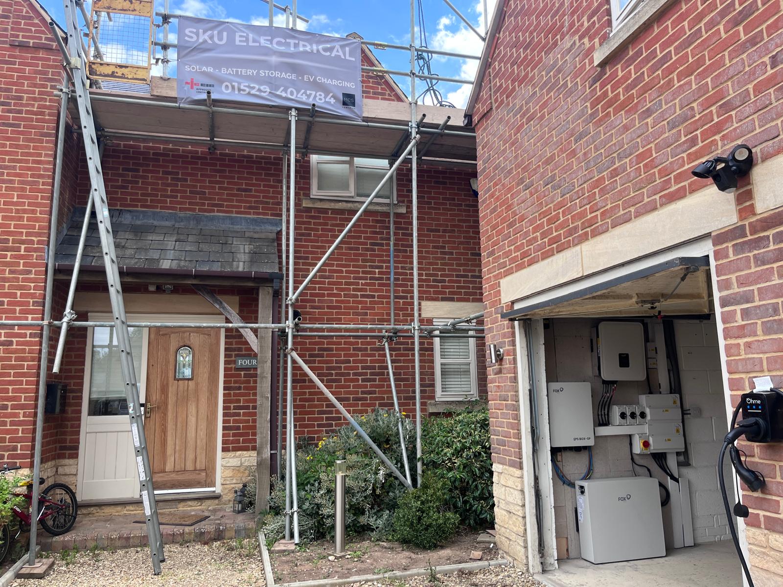 Solar PV battery storage and inverter installation in progress at a residential property